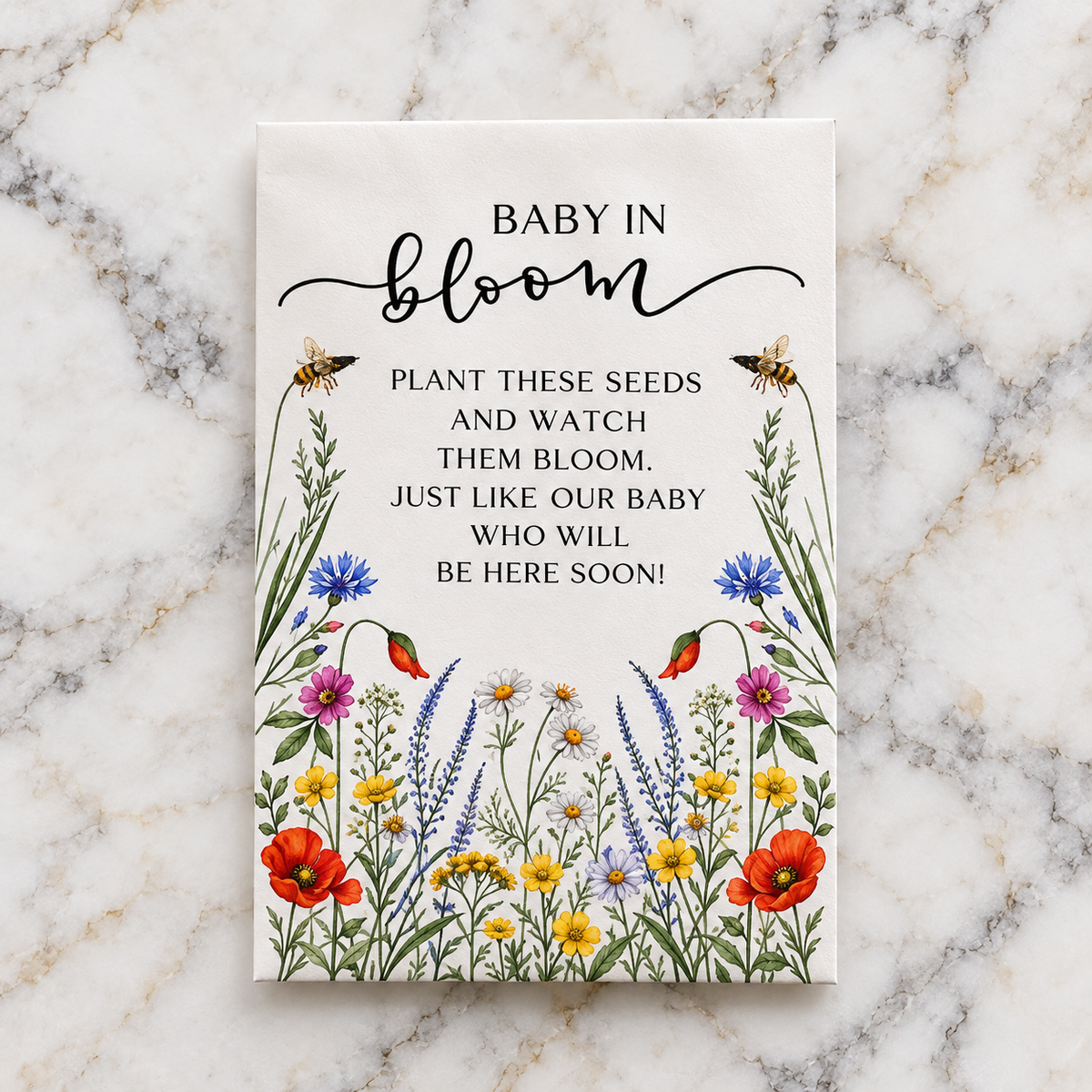 The Baby in Bloom wildflower seed packet, illustrated with poppies, cornflowers and daisies, reading Plant these seeds and watch them bloom
